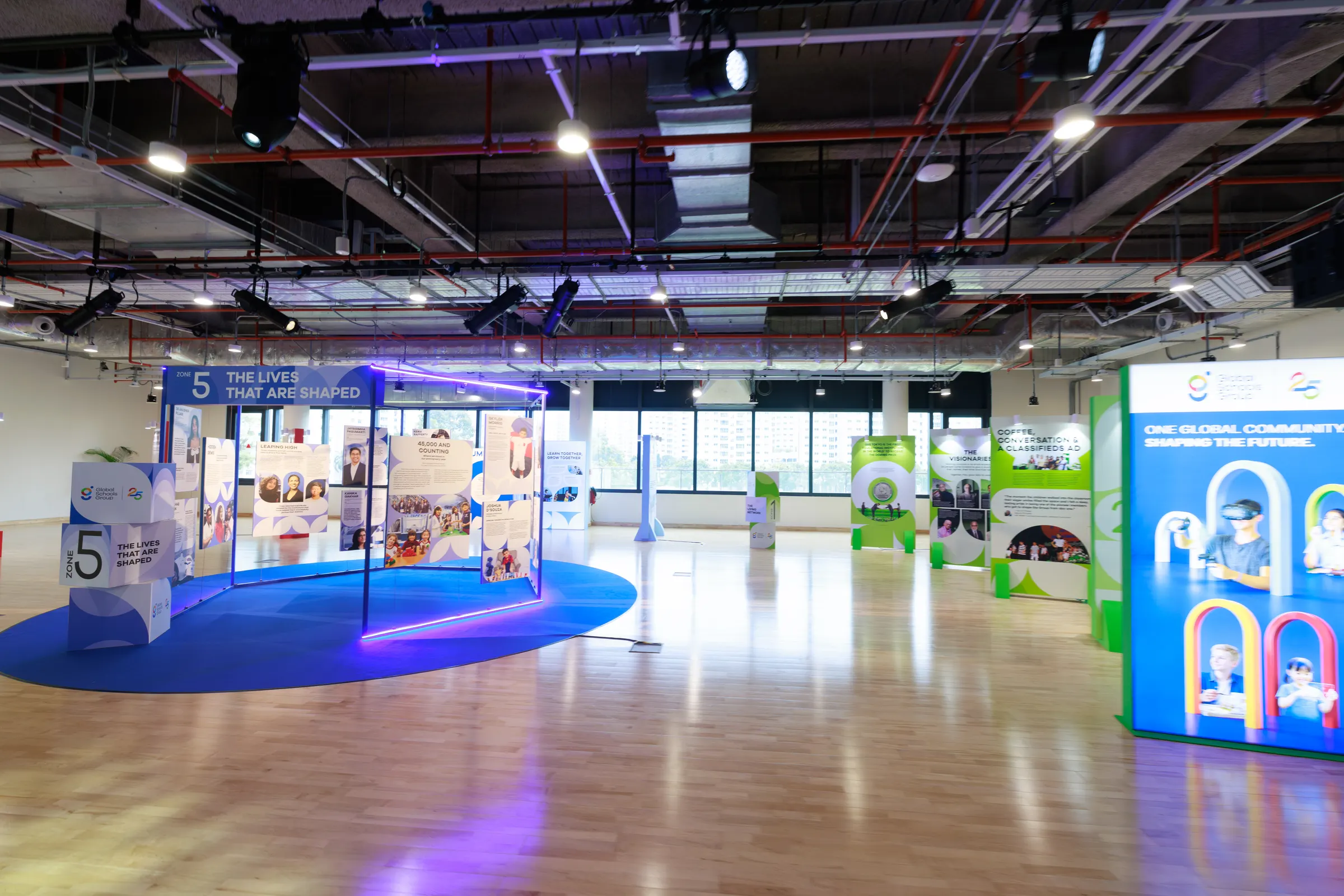 The GSG25 anniversary gallery, with colour-coded zone panels and the Zone 5 structure, "The Lives That Are Shaped".