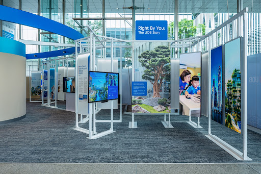 A visitor engaging with an interactive display in The UOB Gallery