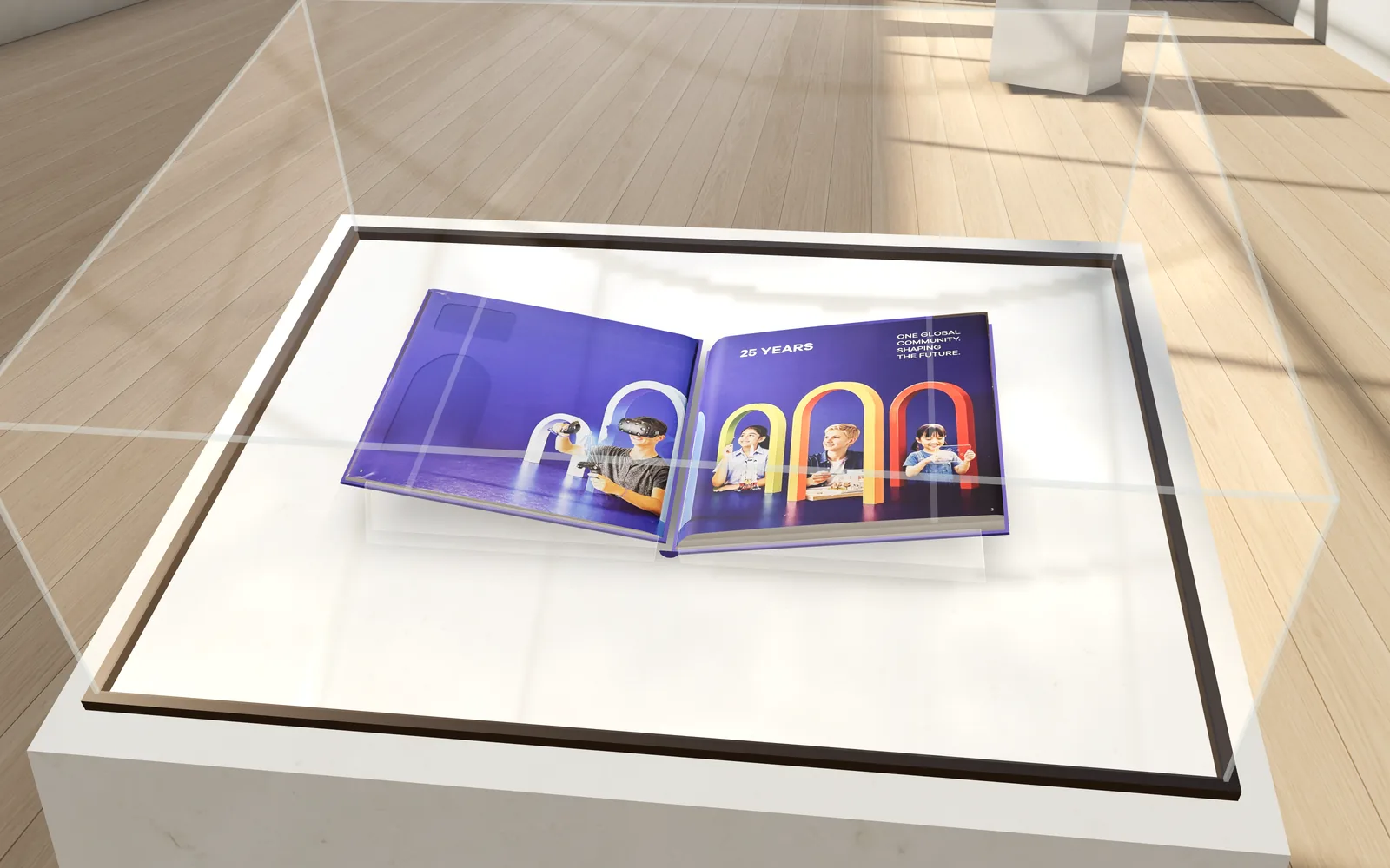 The GSG25 book lying open at the ‘25 Years’ spread on a raked clear cradle under a low glass hood